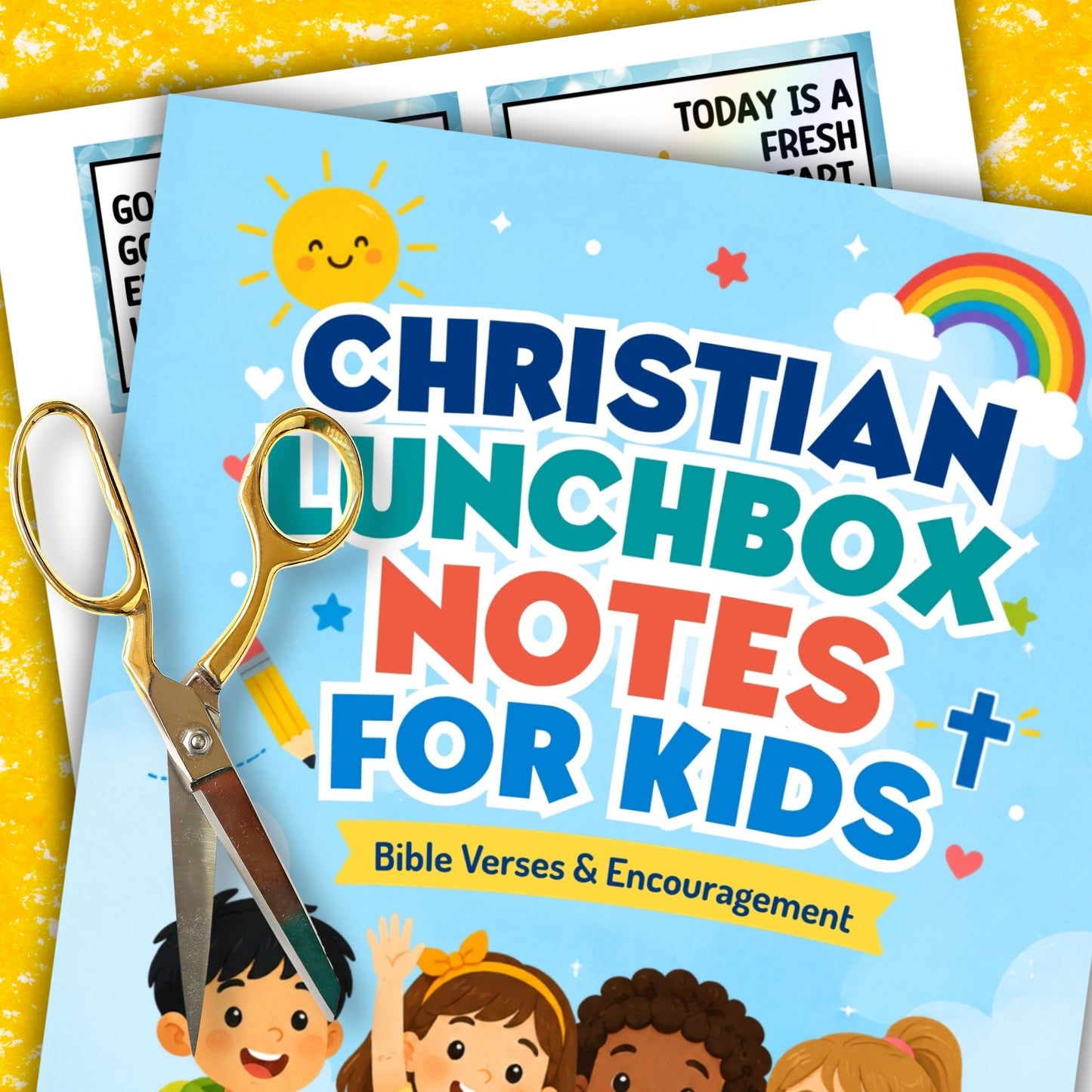 A colorful printed note sheet titled "CHRISTIAN LUNCHBOX NOTES FOR KIDS" with Bible verses and encouragement, shown with gold-handled scissors on a yellow textured background. The sheet includes cartoon children, a sun, stars, hearts, and a rainbow.